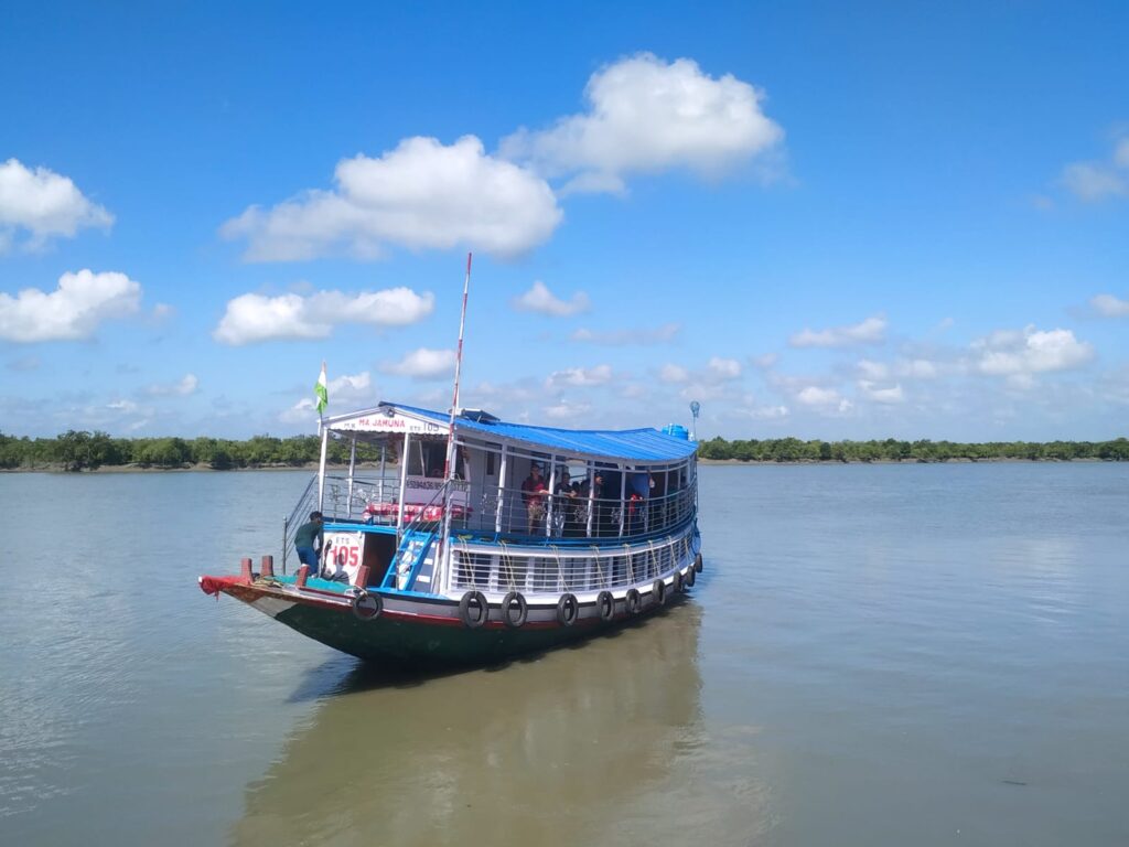 Tourist boat cruising through Sundarban waterways during a Sundarban tour package from Kolkata